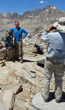 Katchan takes Merle's photo at the summit, Behind: the switchback descent on the north side