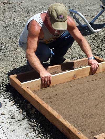 Ivan is screening the sand to level the blocks, Behind: Ivan and Steve work on the patio.