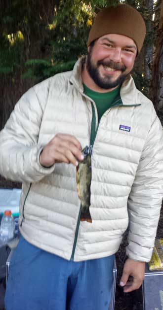 Andrew, the crew leader, shows off his only catch, Behind: Scout Lake in Jefferson Park