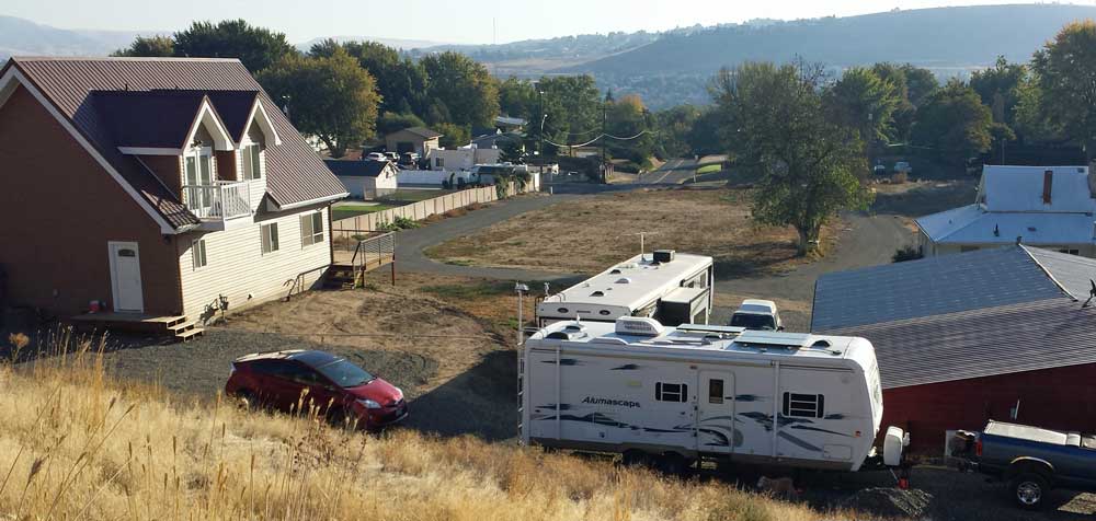 Our camp location with Wayne and Char, Behind: night view of Clarkston Washington and Lewiston, Idaho