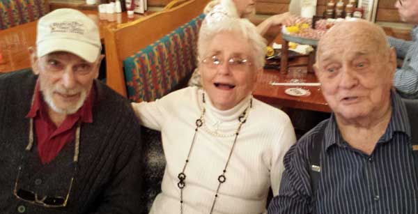 My mother with her two cousins, behind: visiting over a meal