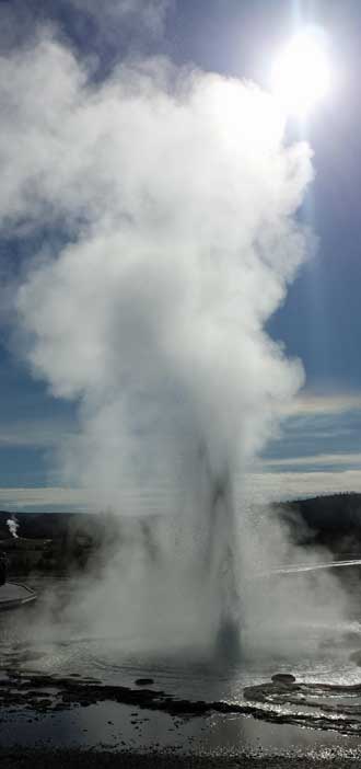 One of the many steam geysers, Behind: Boardwalk through the geyser field