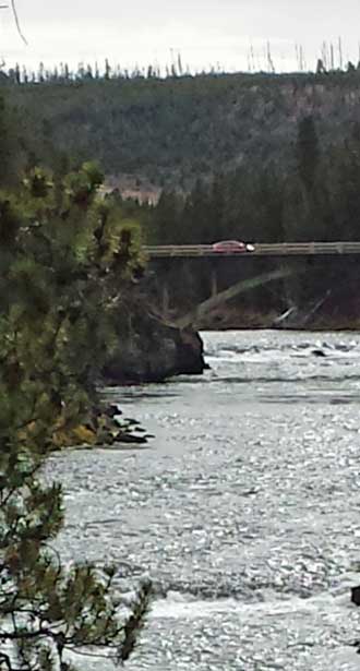 Gwen crossing the Yellowstone River in the Prius, Behind: Brink of Upper Falls