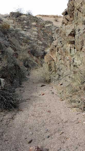 No trails here, just hiking the wash, Behind: Enjoying the hike