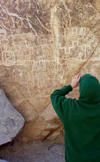 Gwen photographing petroglyphs, Behind: some I found further up the canyon