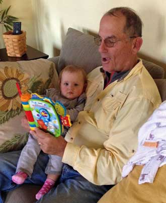 Grandpa reading and singing to Lucy