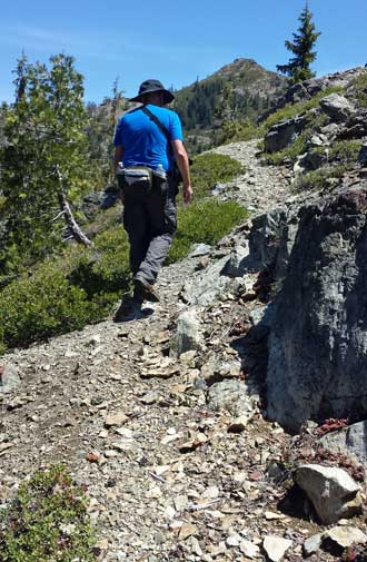 The hiking is steep, behind: Lane attempts to fish with his trekking pole