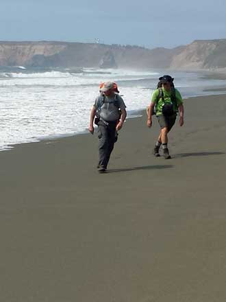 Dodging the waves, behind is Richard doing his "famous" hiking pose