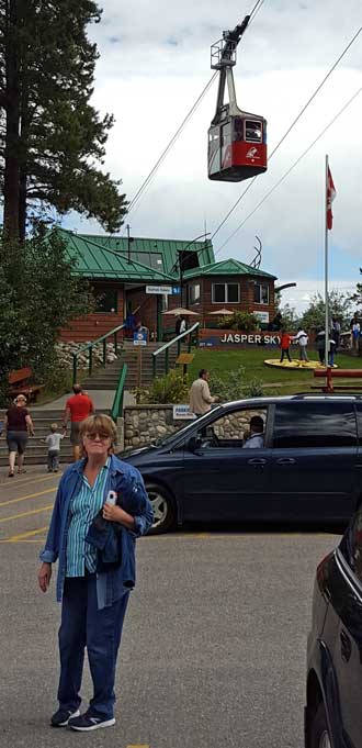 Gwen in the Gondola parking lot and a view of Jasper while ascending the gondola