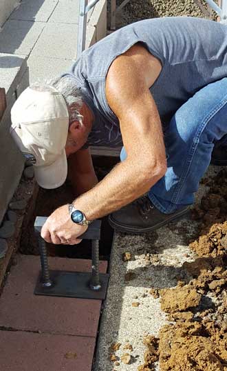 Ivan is preparing the hole for a support post