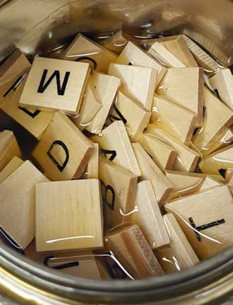 Some of the wood parts for the tank car are alphabet tiles soaking in Polyurathane