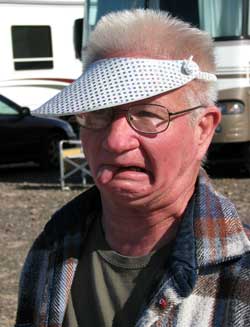 Tom, the washer toss champion, waits for his final turn