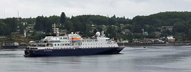 The Silver Discoverer anchored in the bay