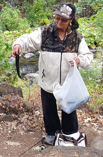 Native American showing the fish she caught