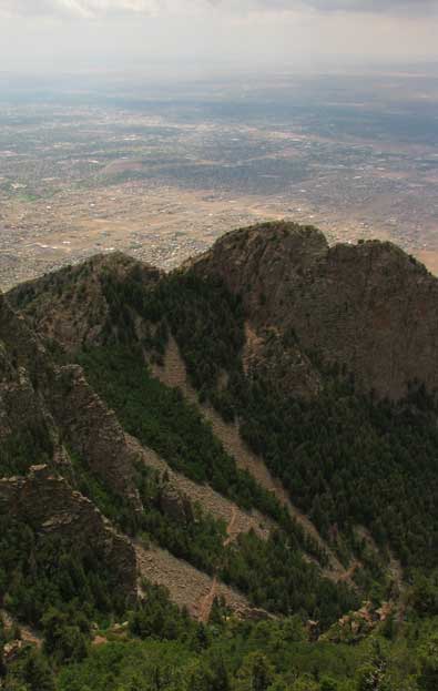 View of Albuquerque with a trail up the west side of the Sandia Mountains