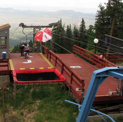 Ski lift is running a delivers passengers very near the upper tram building on the east side of the mountain