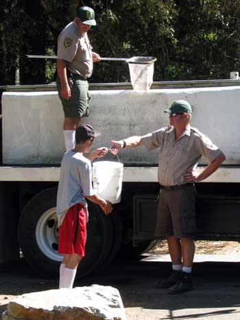 California Fish and Wildlife arrived today to stock the river with fish. All the camp kids came running to help