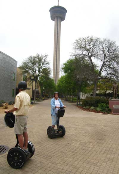 In front of the Tower of the Americas, behind, in front of the Alamo