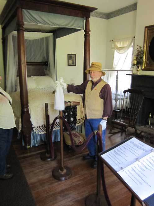 Master bedroom, guide is holding a pew doll