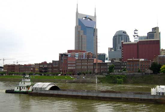 Traci K pushes a load down the Cumberland River then returns up river for another load behind the front photo