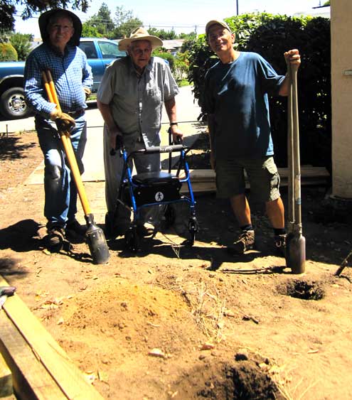 Planning and building a short fence with a gate, digging the post holes.