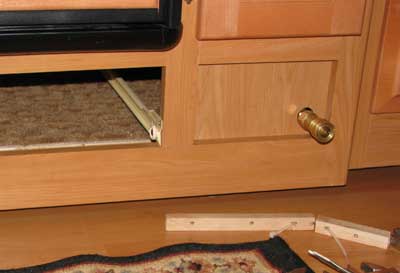 The copper tubing ends under the refrigerator