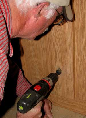 Drilling a hose hole through the cabinet