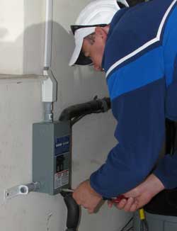 Ben secures the subpanel to the garage wall