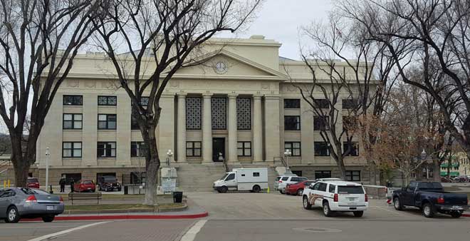 County courthouse surrounded by a plaza with shops surrounding the plaza