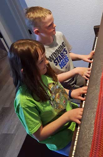 Chloe and Noah practice for a recital