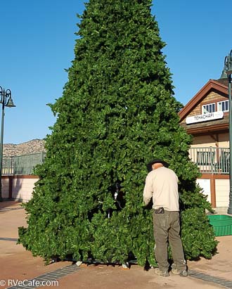 Artificial Christmas tree with many boxes of ornaments