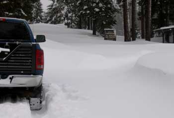 The road continues into the campground to the left of the sign.