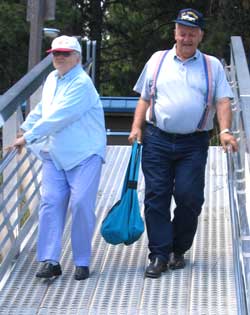 The parent are careful walking down the steep marina ramp