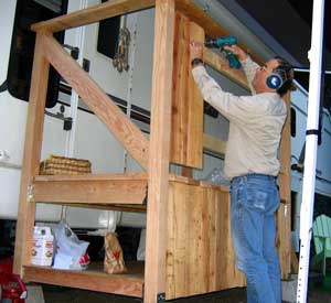 The rough cedar fence boards are added