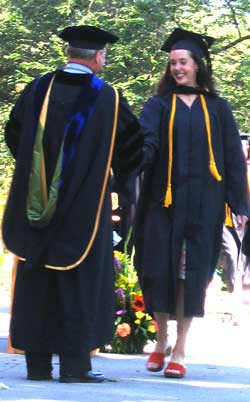 After a wave to the crowd, Kim receives her diploma with dignity