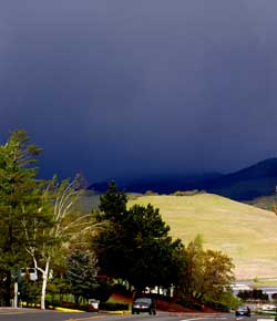 The view of the mountain from Ashland. The mountain is buried under a very dark storm cloud.