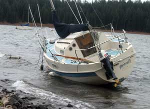 A storm brings one of the sailboats ashore