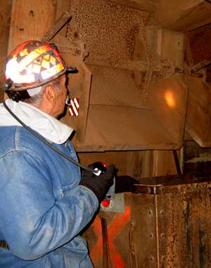 Neto shows a shute which pours into an ore car. Each level is 100 feet apart so the next higher level is 100 feet above this level