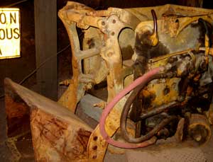 The loader rolls to the ore on rails and scoops the ore into ore cars behind it