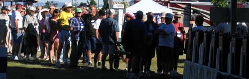 Lining up for free coffee and donuts, coffee in the dark containers on the right.