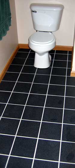 The new toilet and tile are installed